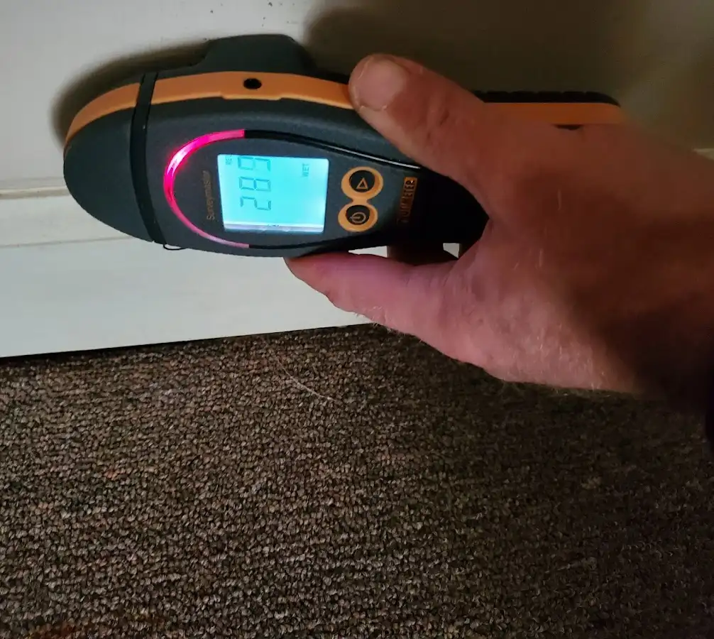 Moisture detection at baseboard during Storm Damage Restoration in Prairie View